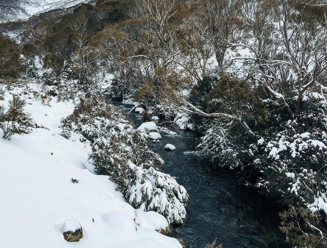 a natural river cutting through  snowy landscape